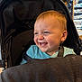 Grayson joined the competition — help win amazing prizes! baby, stroller, smile, face, child, indoor, happy, blue_shirt, seat, hair, food_crumbs, store, shopping, person, infant, cute, seatbelt, head, expression, light