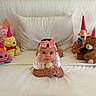 Valentina joined the competition — help win amazing prizes! baby, infant, pink_bow, white_bed, stuffed_animals, party_hats, teddy_bear, octopus_toy, winnie_the_pooh, tigger, plush_toys, cute, indoors, child, smiling, toy, soft_toys, celebration, laying_down, colorful