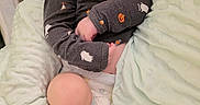 Mack is registered to the contest to win money with this photo: baby, infant, sleeping, nap, portrait, face, closed_eyes, blanket, bed, pajamas, clothing, cozy, indoors, home, nursery, peaceful, resting, curled_up, soft_lighting, photography