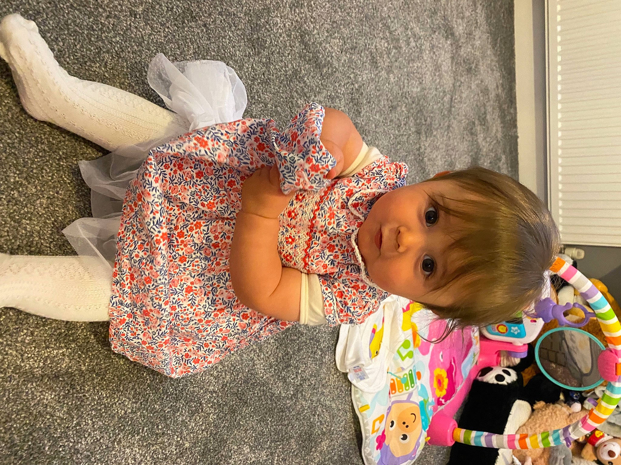 Adalynn joined the competition — help win amazing prizes! arm, baby, baby_toddler_clothing, child, dress, foot, happy, human_body, human_leg, knee, orange, pattern, person, plant, sitting, thigh, toddler, toy, tree, trunk