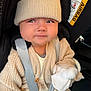 baby, car_interior, car_seat, child, closeup, clothing, cute, expression, fashion, hat, infant, knitwear, mittens, person, pom_pom, portrait, seatbelt, sitting, straps, warm