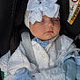 baby, blue_clothing, bundle, car_interior, car_seat, child, closeup, cute, headwear, indoors, infant, knitwear, mittens, peaceful, portrait, seatbelt, sleeping, soft_texture, tiny_hands, white_bow
