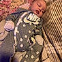 Jarrett joined the competition — help win amazing prizes! baby, sleeping, onesie, nike, pacifier, blanket, cushion, soft_fabric, indoor, child, infant, cozy, smiley_face, clothing, comfort, rest, face, hand, footwear, relaxation