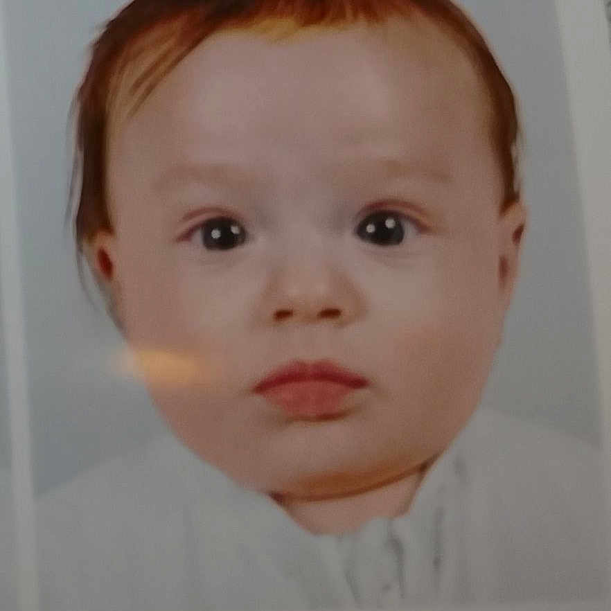 Sanja participe au concours pour gagner de l'argent avec cette photo : baby, border, closeup, expressionless, eyes, face, gaze, hair, headshot, infant, mouth, passport_photo, photograph, portrait, reflection, skin, studio_style, white_background, white_clothing, young_child