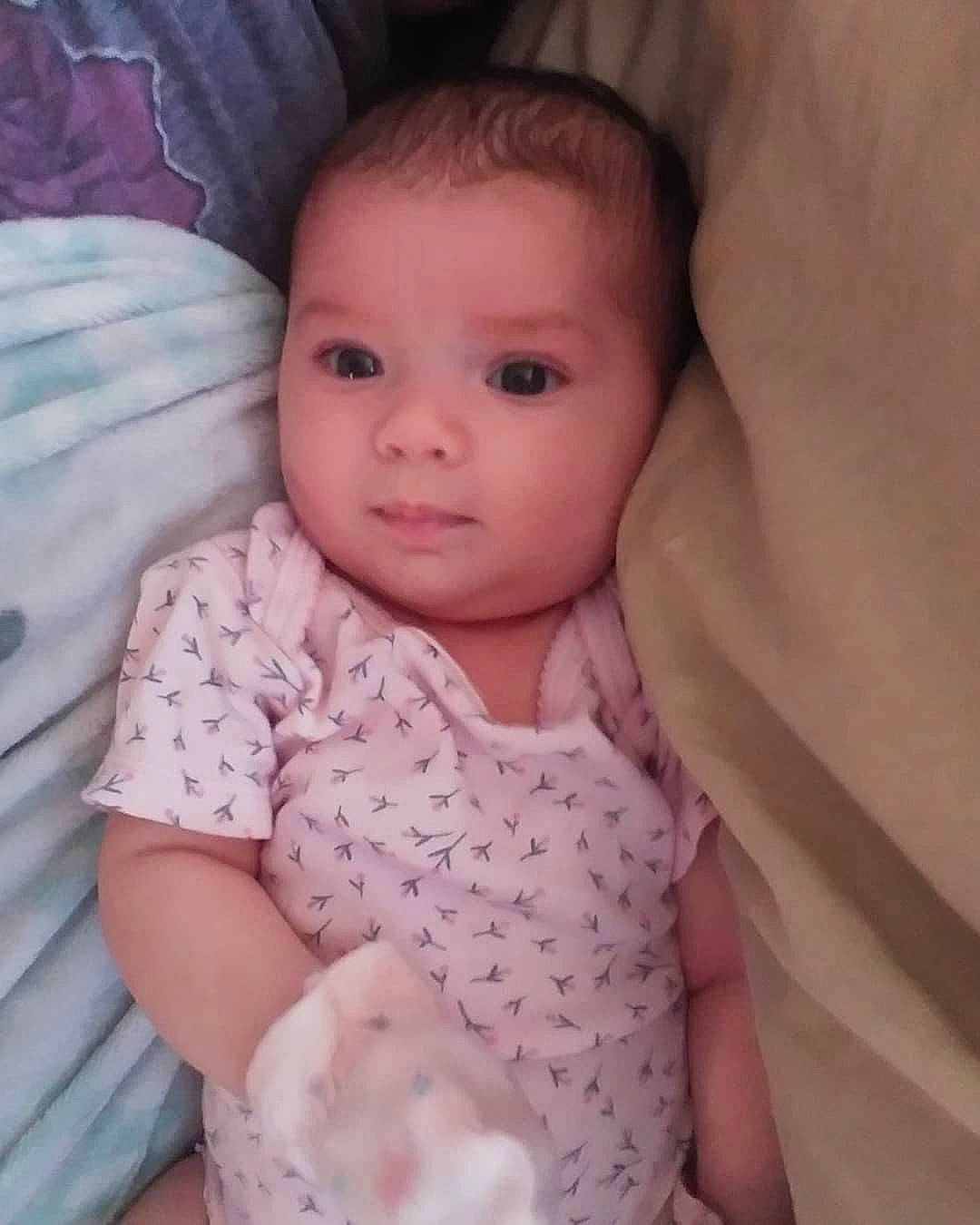 Laura is registered to the contest to win money with this photo: baby_toddler_clothing, cheek, chin, comfort, eye, eyebrow, eyelash, gesture, hand, head, human_body, iris, lip, mouth, neck, nose, person, skin, sleeve, smile