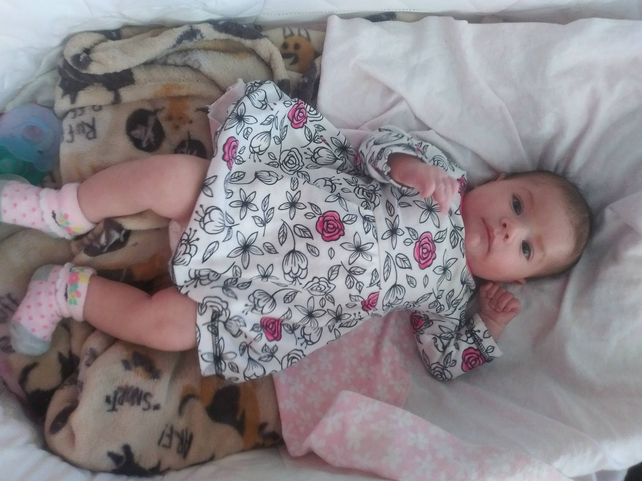 Laura is registered to the contest to win money with this photo: arm, baby, baby_toddler_clothing, cheek, child, clothing, comfort, finger, hand, human_body, leg, linens, mammal, pattern, person, pink, skin, sleeve, textile, thigh