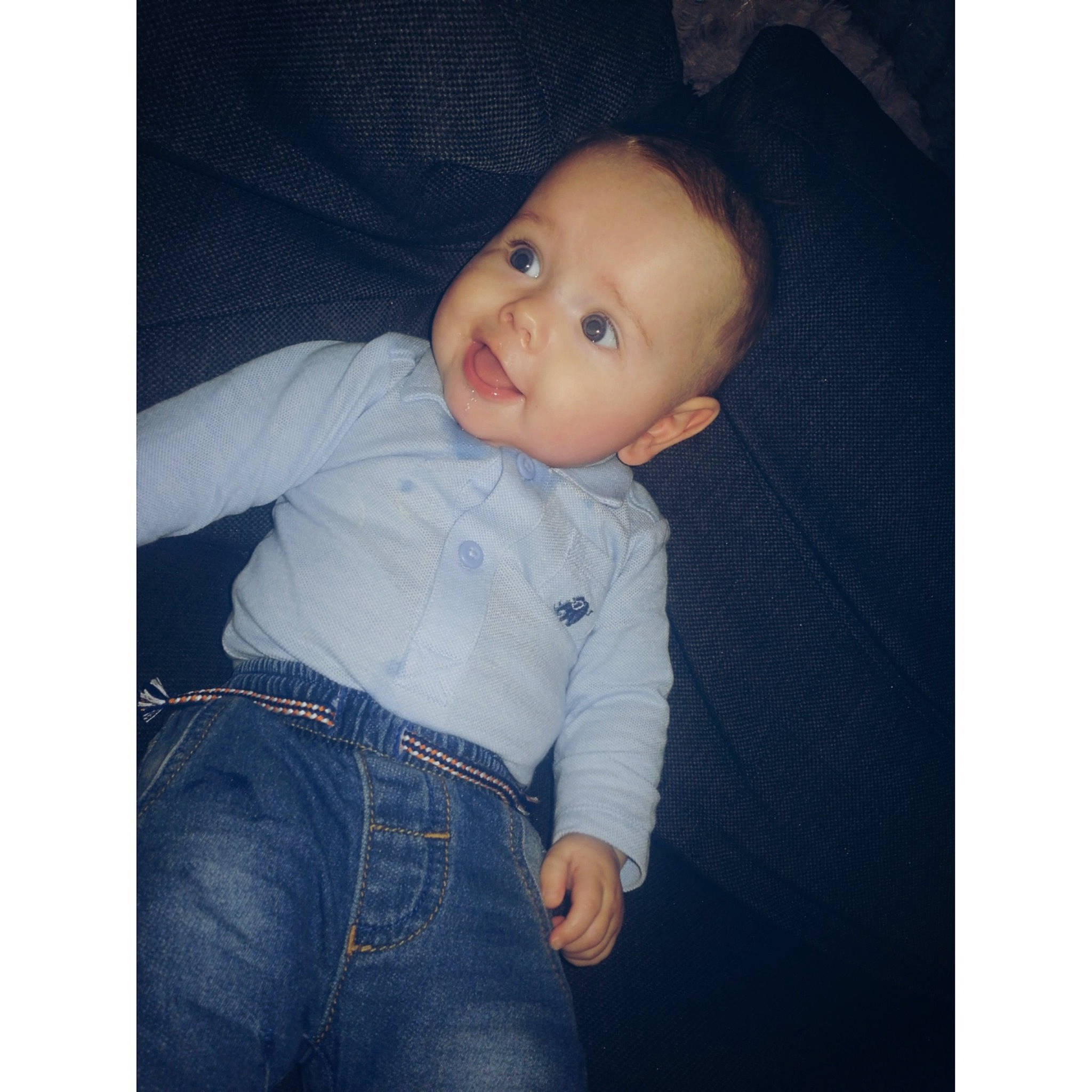 Malakai is registered to the contest to win money with this photo: arm, baby, blue, cheek, child, cloud, cool, denim, eye, head, jeans, lip, nose, person, photography, product, skin, sleeve, standing, t_shirt