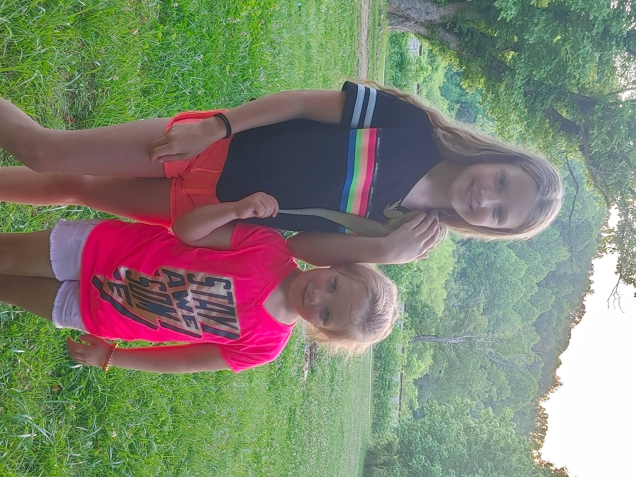 Kendall is registered to the contest to win money with this photo: elbow, fun, grass, happy, human_leg, joy, landscape, leisure, people_in_nature, person, plant, shorts, smile, sunglasses, t_shirt, thigh, tree, waist