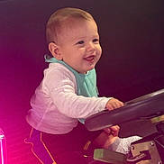 Elian joined the competition — help win amazing prizes! baby, child, smiling, steering_wheel, vehicle, play, cute, happy, clothing, socks, indoors, seat, toy, young_child, joyful, portrait, infant, casual, fun, seatbelt