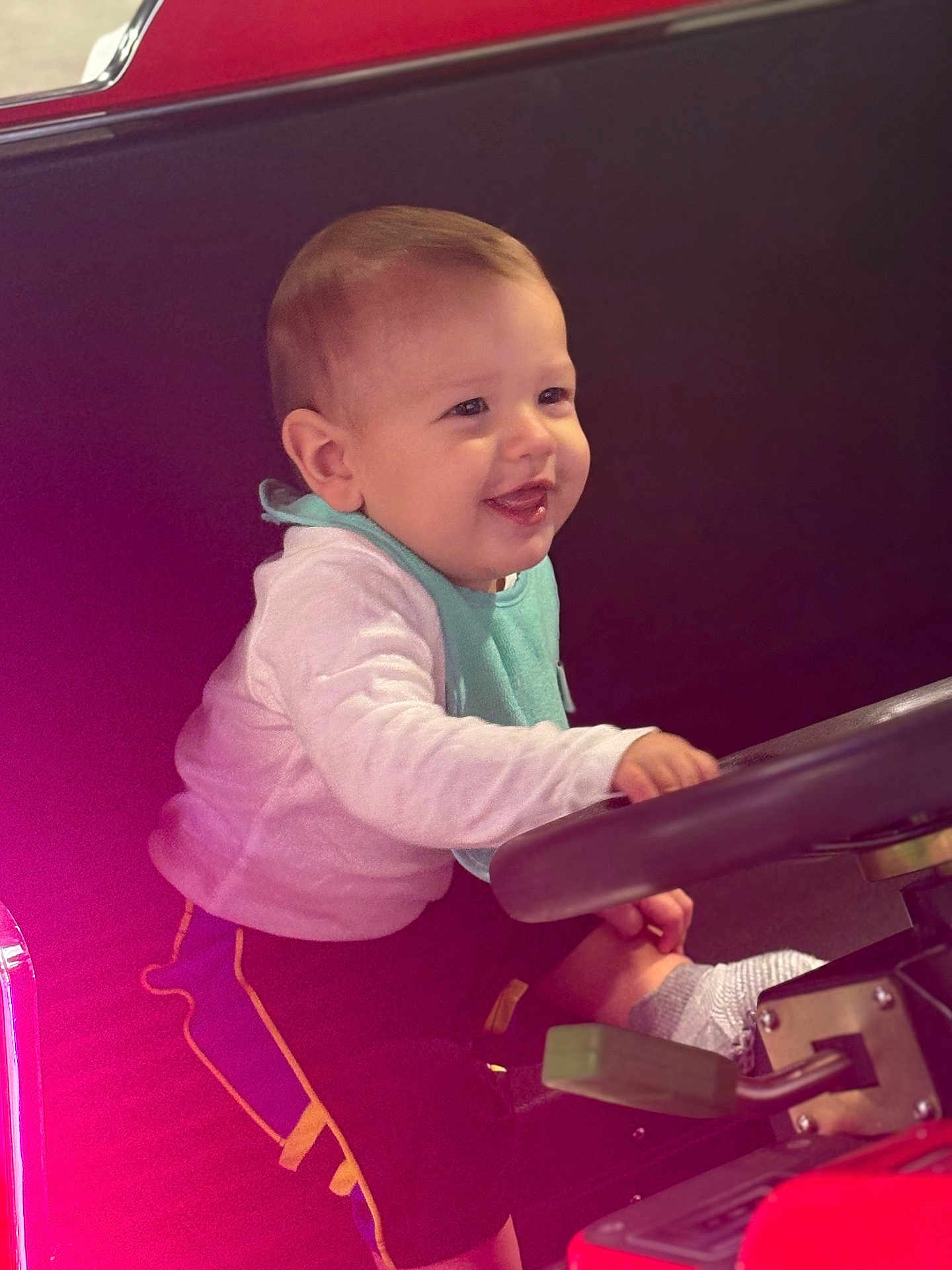 Elian joined the competition — help win amazing prizes! baby, child, smiling, steering_wheel, vehicle, play, cute, happy, clothing, socks, indoors, seat, toy, young_child, joyful, portrait, infant, casual, fun, seatbelt