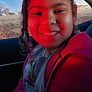 Sophia joined the competition — help win amazing prizes! child, girl, smiling, car, headband, braids, beads, red_light, window, outdoor, portrait, casual_clothing, happy, seat, interior, young, person, face, hair, jacket