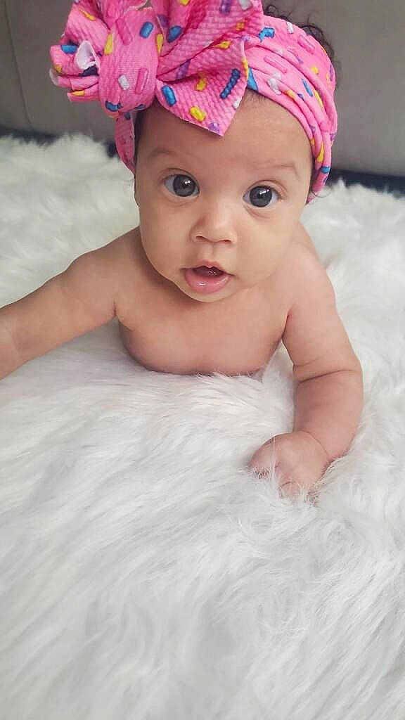 Sorraya is registered to the contest to win money with this photo: baby, baby_toddler_clothing, cap, child, comfort, costume_hat, fashion_accessory, flash_photography, fun, hair_accessory, happy, headband, headpiece, headwear, linens, magenta, person, pink, skin, smile