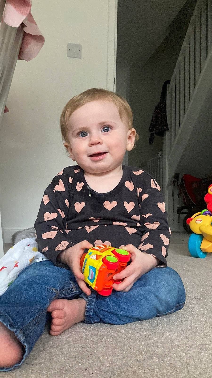 Harriet joined the competition — help win amazing prizes! baby, baby_playing_with_toys, baby_toddler_clothing, cheek, child, curtain, flooring, fun, happy, holiday, joy, orange, person, play, room, sitting, smile, standing, t_shirt, toddler