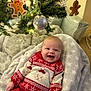 Frankie is registered to the contest to win money with this photo: baby, smiling, christmas_tree, ornaments, gingerbread_man, red_sweater, bear_design, blanket, holiday, festive, happy, indoors, decoration, couch, cozy, child, face, infant, celebration, winter_clothing