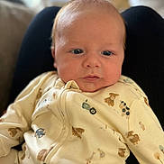 Frankie joined the competition — help win amazing prizes! baby, infant, onesie, animal_print, cute, face, blue_eyes, soft_lighting, close_up, indoor, child, newborn, portrait, person, comfortable, seated, background_blur, skin, expression, cozy