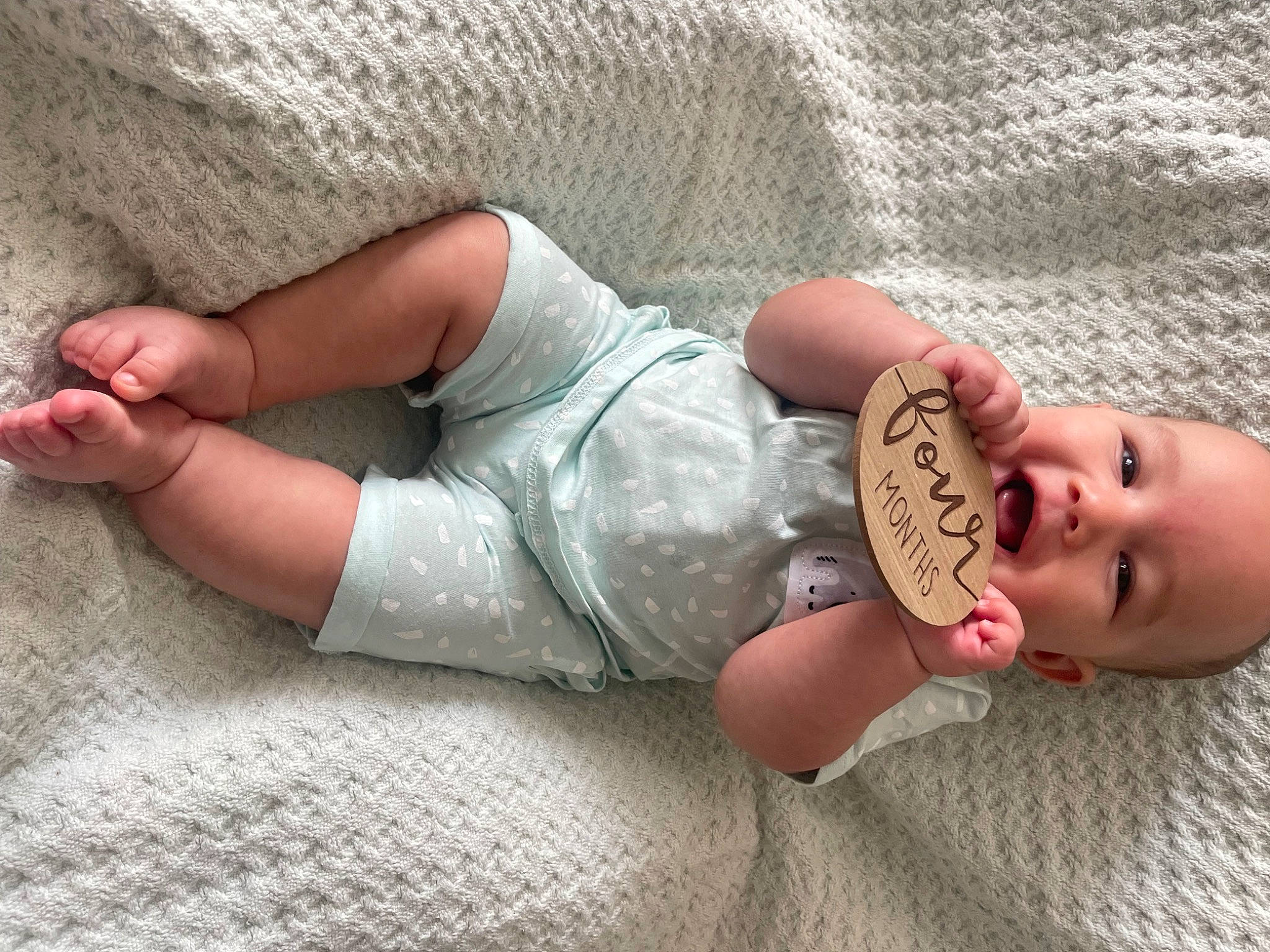 Kane is registered to the contest to win money with this photo: arm, baby_toddler_clothing, child, comfort, finger, foot, gesture, glasses, hand, happy, human_body, joint, knee, leg, mouth, nail, person, skin, thigh, thumb