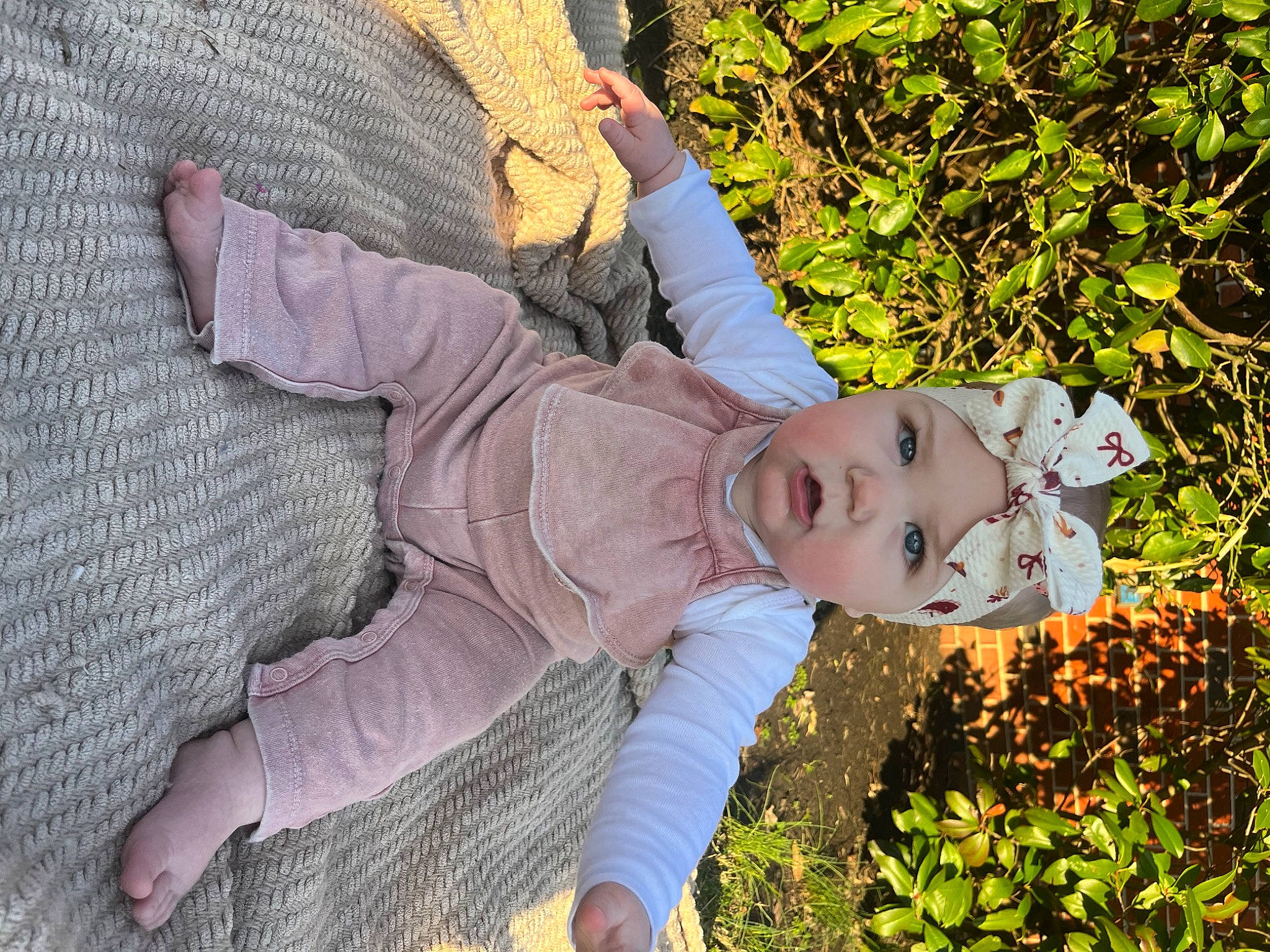 Blake is registered to the contest to win money with this photo: autumn, child, fun, garden, grass, grass_family, happy, headwear, leisure, pattern, people_in_nature, person, photo_shoot, plant, portrait_photography, shrub, sitting, soil, textile, tree