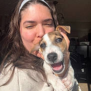 Bambú is registered to the contest to win money with this photo: brown_hair, cuddling, dog, eyes, happy, headband, hug, indoor, kiss, long_hair, nose, paw, person, pet, portrait, puppy, smile, sunlight, sweatshirt, teeth