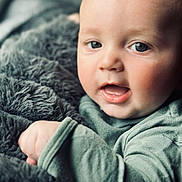 Walker joined the competition — help win amazing prizes! baby, child, face, eyes, blanket, fuzzy, cozy, infant, portrait, close_up, skin, expression, mouth, hand, clothing, soft, warm, indoors, young, cute