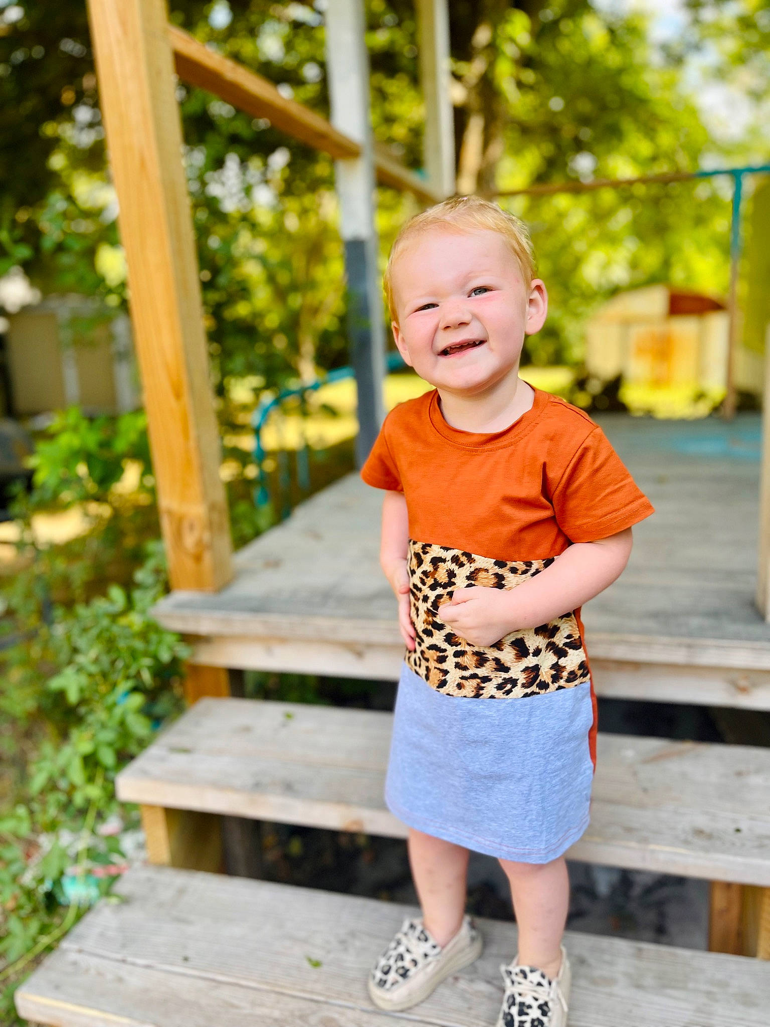 Brinley is registered to the contest to win money with this photo: baby_toddler_clothing, blond, child, fun, grass, happy, joy, leaf, leisure, pattern, people_in_nature, person, plant, shorts, sitting, sleeve, smile, summer, t_shirt, toddler