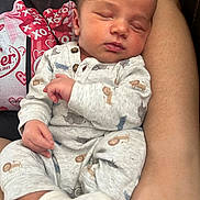 Koa joined the competition — help win amazing prizes! baby, sleeping, infant, onesie, animal_print, sock, arm, person, closeup, comfort, rest, cute, newborn, peaceful, cuddling, casual_clothing, indoor, portrait, tender, human