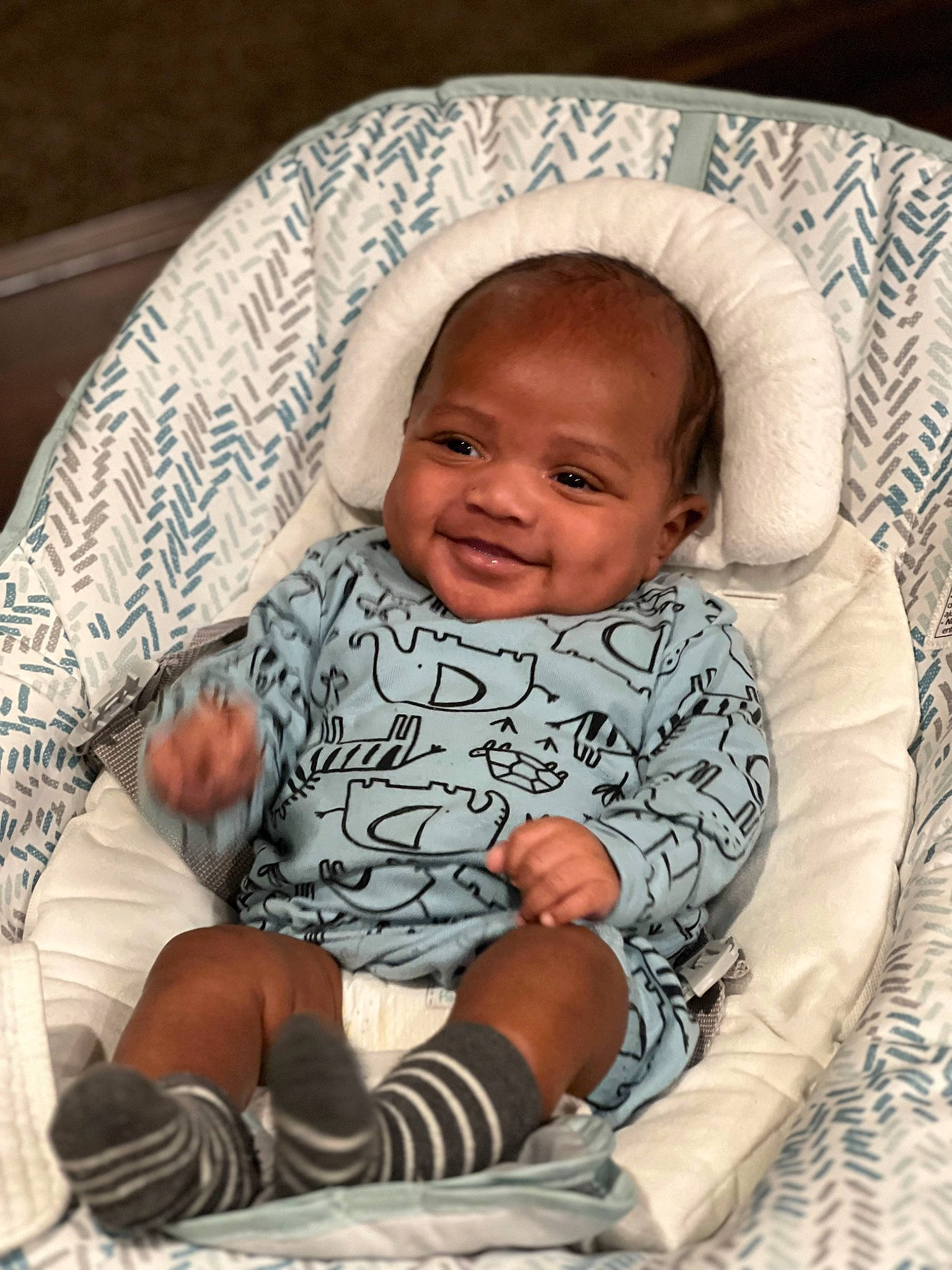 Dominic is registered to the contest to win money with this photo: baby, baby_products, baby_toddler_clothing, cheek, child, comfort, face, facial_expression, happy, joy, lap, laugh, linens, pattern, person, room, sitting, skin, sleeve, smile
