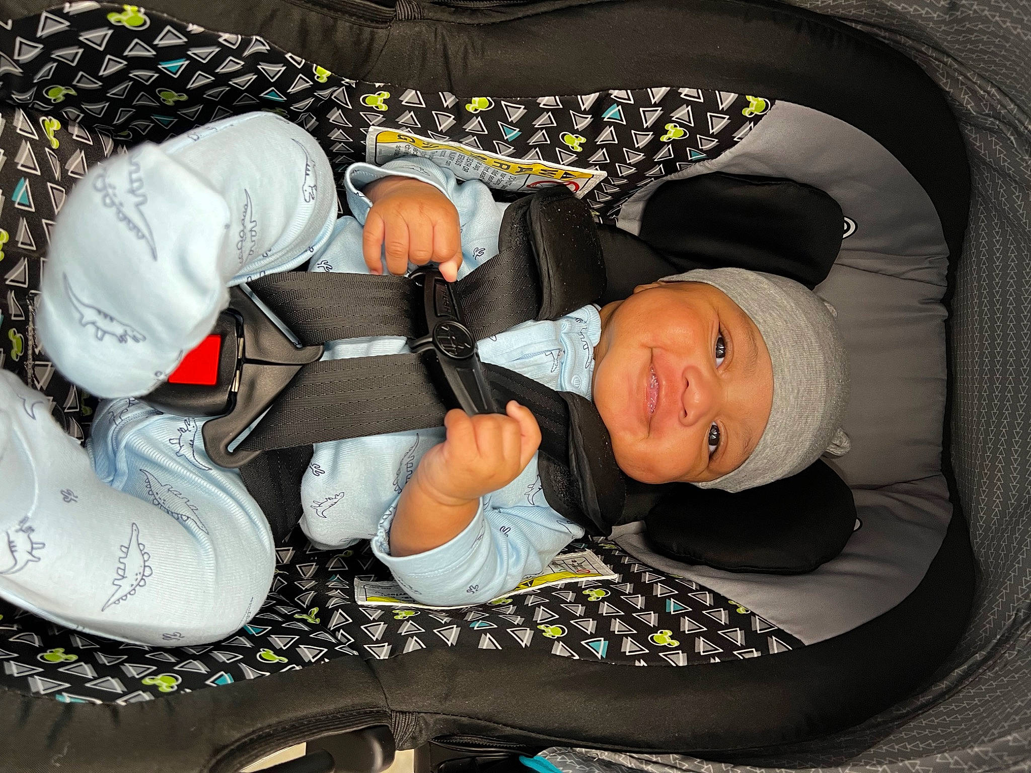 Dominic is registered to the contest to win money with this photo: auto_part, baby, baby_carriage, baby_in_car_seat, baby_products, baby_safety, baby_sleeping, baby_toddler_clothing, car_seat, carmine, child, comfort, finger, head, headwear, lap, nap, pattern, person, sitting