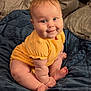 Ayda joined the competition — help win amazing prizes! baby, child, infant, yellow_clothing, smile, blue_blanket, pillow, bed, cute, skin, foot, hand, chubby, sitting, indoors, portrait, happy, plush, young, cozy