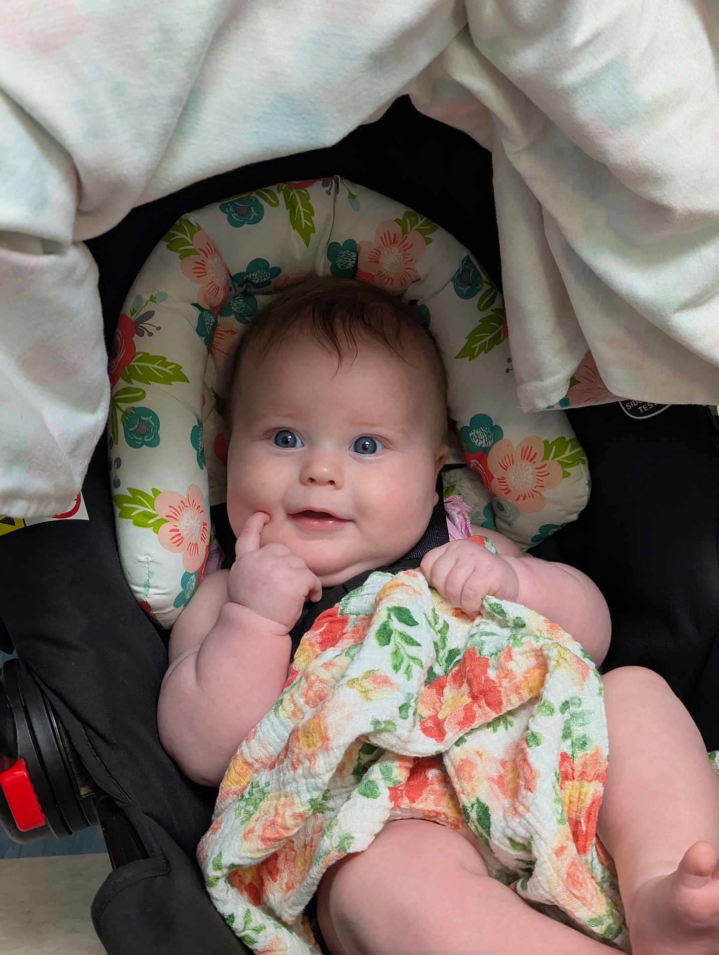 Ayda joined the competition — help win amazing prizes! baby, infant, blue_eyes, car_seat, blanket, floral_pattern, cute, child, person, skin, hand, face, smile, sitting, indoors, clothing, cheeks, head, happy, young