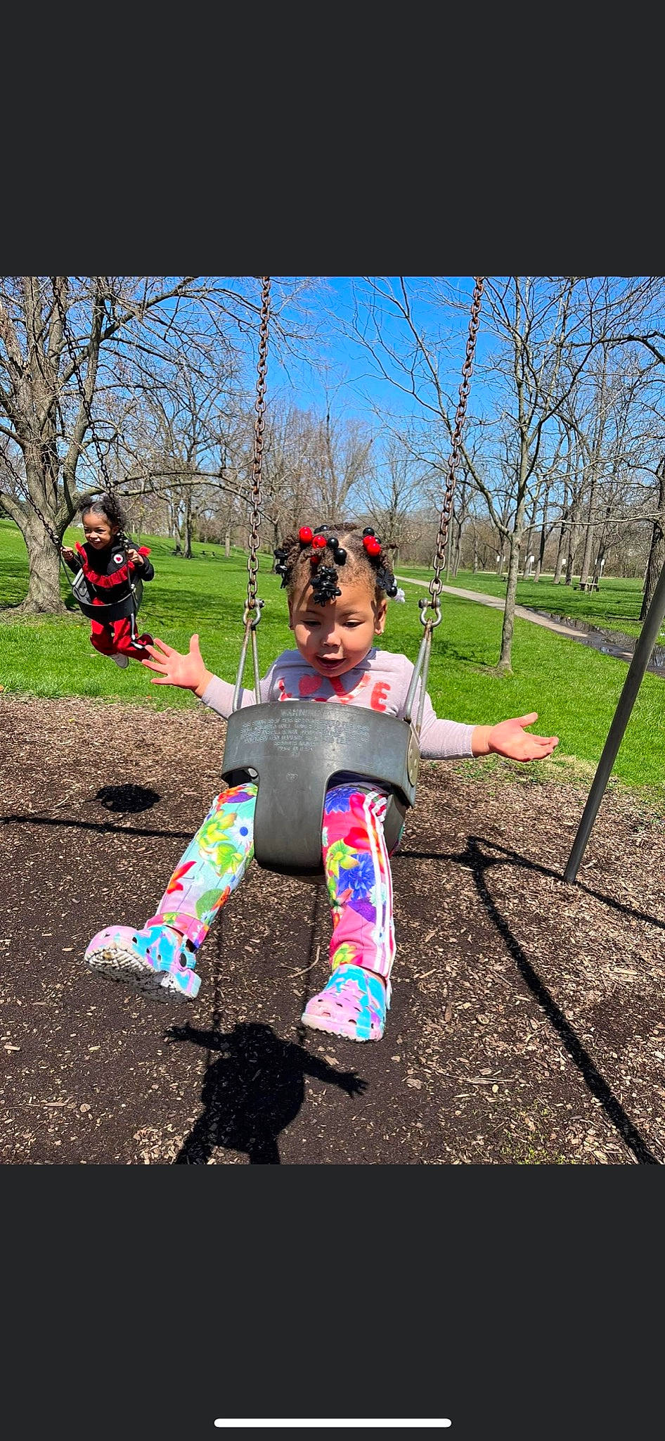 Aribella is registered to the contest to win money with this photo: asphalt, baby, city, eyewear, fun, grass, happy, joy, leisure, outdoor_play_equipment, people_in_nature, person, plant, play, playground, recreation, sky, soil, swing, t_shirt