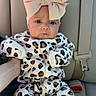 Blakley joined the competition — help win amazing prizes! baby, infant, car_seat, animal_print, leopard_print, headband, bow, clothing, onesie, seatbelt, hand, person, cute, child, indoor, portrait, face, sitting, car_interior, young_child
