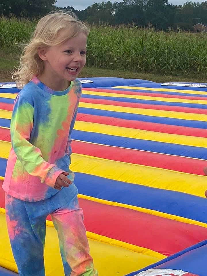 Brooklyn is registered to the contest to win money with this photo: child, electric_blue, fun, grass, happy, joy, leisure, magenta, outdoor_play_equipment, pattern, people_in_nature, person, plant, play, playground, recreation, sky, smile, t_shirt, toddler