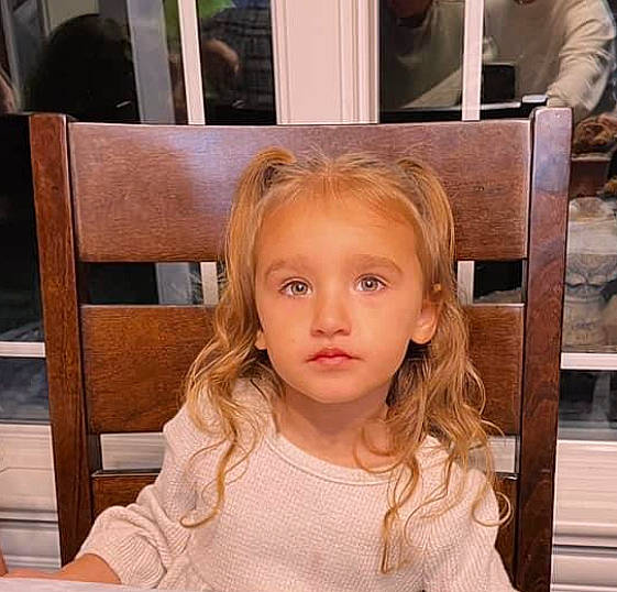 Kinzlie joined the competition — help win amazing prizes! bangs, beauty, blond, brown_hair, chair, cheek, chin, eyebrow, eyelash, flooring, hairstyle, happy, iris, layered_hair, lip, long_hair, nose, person, skin, toddler