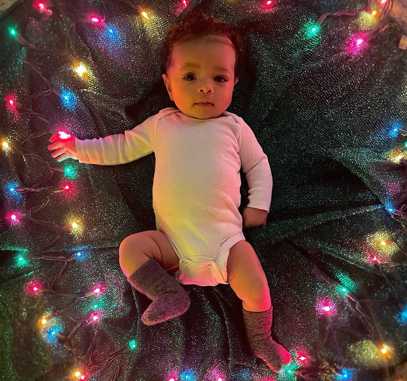 Kashton is registered to the contest to win money with this photo: baby_toddler_clothing, christmas, christmas_decoration, christmas_ornament, event, fun, happy, holiday, light, magenta, ornament, pattern, people_in_nature, person, pink, purple, sleeve, space, standing, toddler