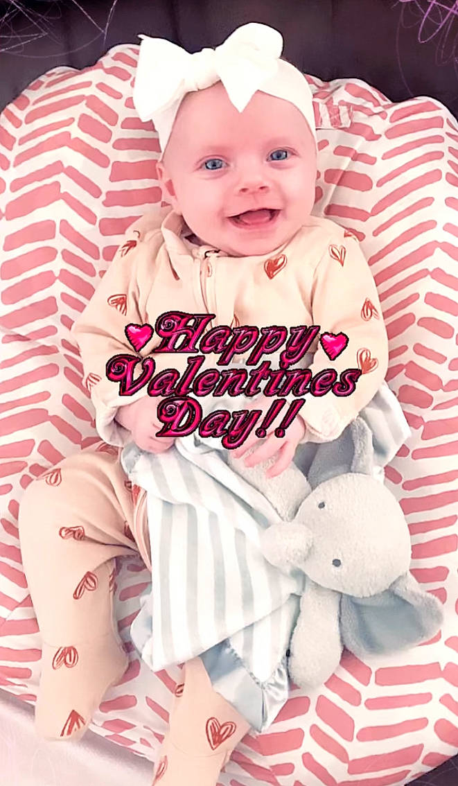 Eva is registered to the contest to win money with this photo: baby, baby_laughing, baby_products, baby_toddler_clothing, cap, cheek, child, costume_hat, event, font, happy, joy, magenta, pattern, person, pink, sitting, sleeve, smile, t_shirt