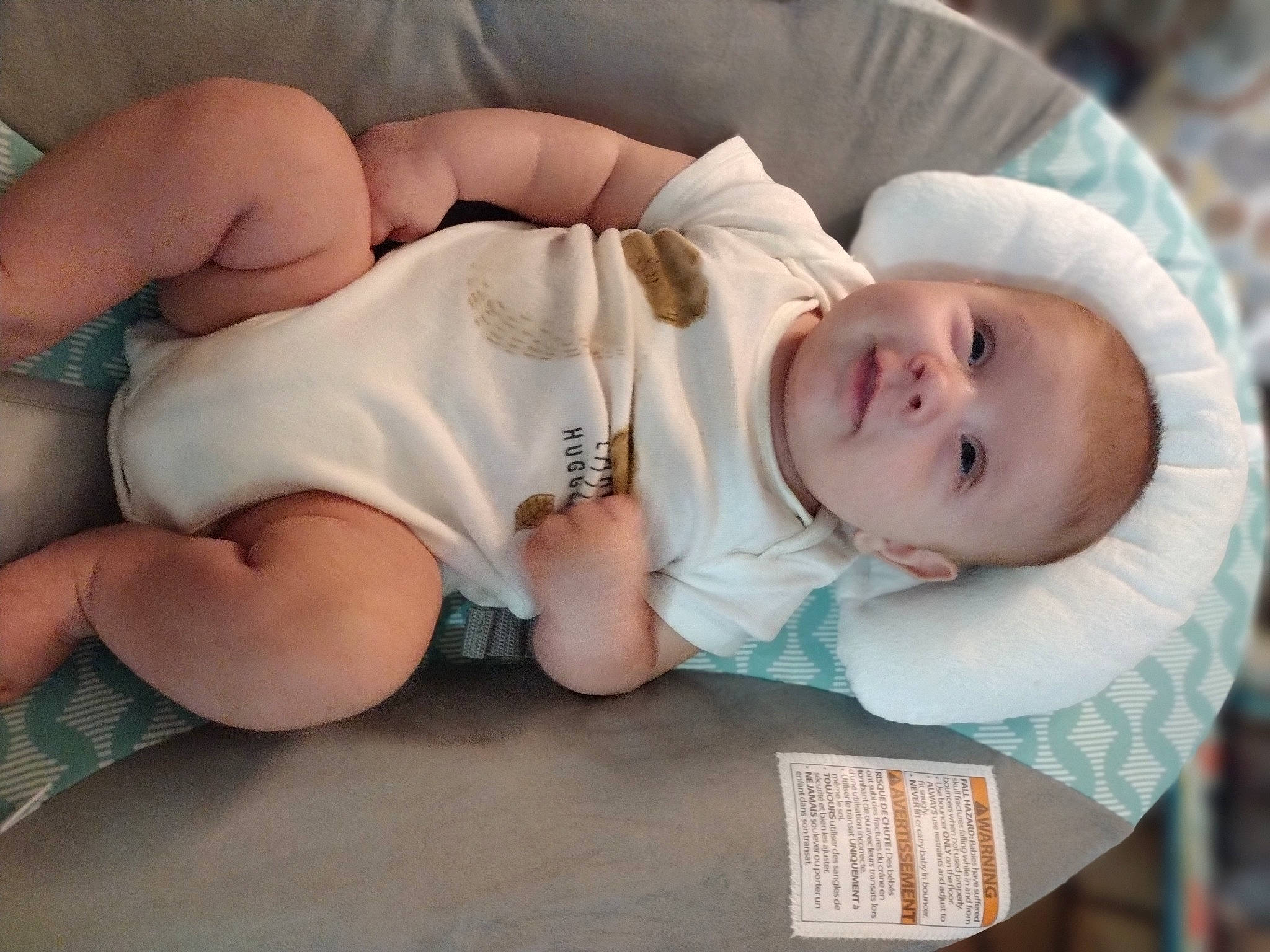 Austin is registered to the contest to win money with this photo: arm, baby, baby_products, baby_sleeping, baby_toddler_clothing, cheek, child, comfort, facial_expression, hand, happy, human_body, human_leg, linens, mouth, person, sitting, skin, sleeve, thigh
