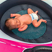 Lavinche Jones is registered to the contest to win money with this photo: baby, close_up, colorful, diaper, face, hair, indoor, infant, lying_down, mesh_mat, newborn, photography, pink, portrait, relaxed, round_basin, skin, sleeping, turquoise, water_droplets