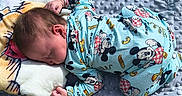 Lavinche Jones is registered to the contest to win money with this photo: baby, bed, blanket, child, cozy, curled_up, indoor, infant, lying_down, mickey_mouse, nap, newborn, pajamas, peaceful, pillow, plush_toy, portrait, sleeping, soft_blanket, textile