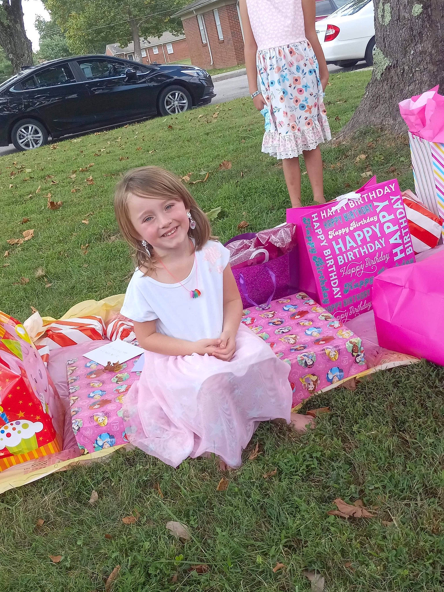 Natalina is registered to the contest to win money with this photo: car, dress, event, fun, grass, happy, joy, lawn, people, person, pink, plant, recreation, shorts, smile, summer, textile, tire, toddler, vehicle