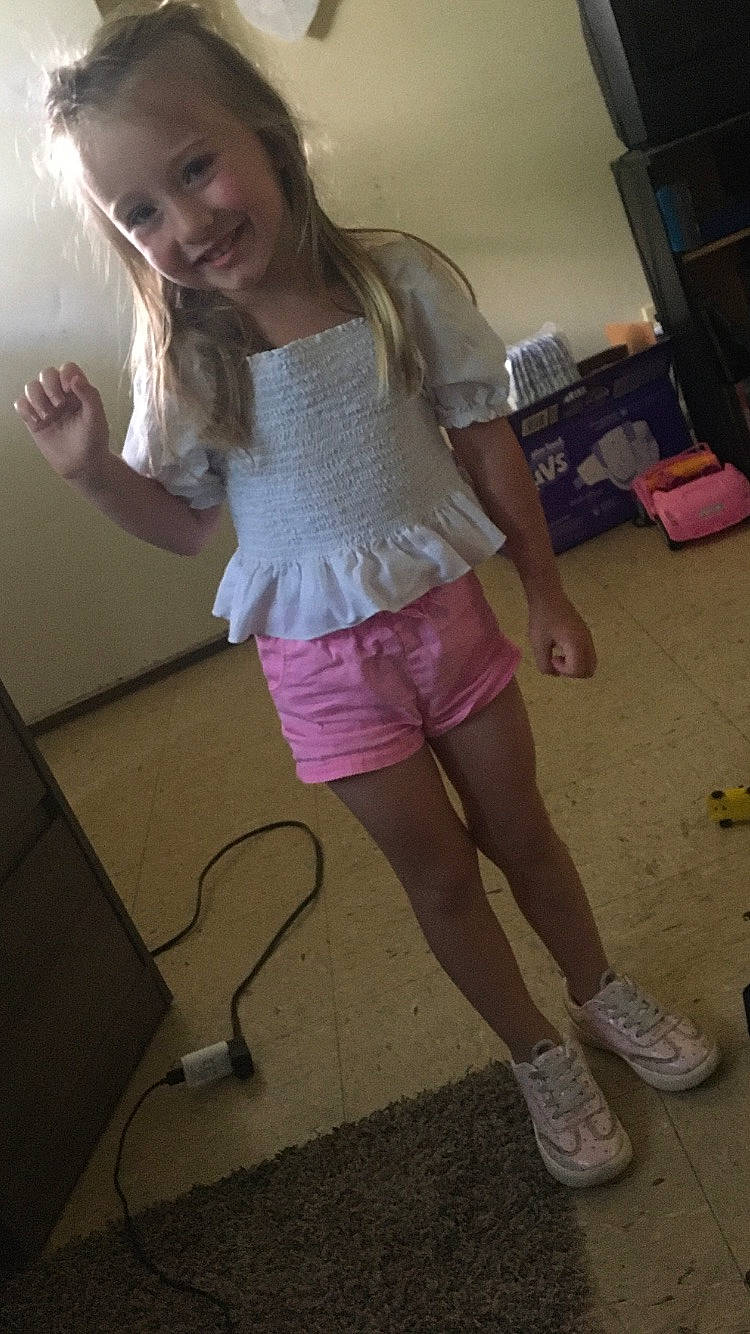 Natalina is registered to the contest to win money with this photo: fun, hair, happy, human_leg, joint, joy, knee, leg, long_hair, mouth, person, pink, shoe, shorts, shoulder, sleeve, smile, sneakers, standing, thigh