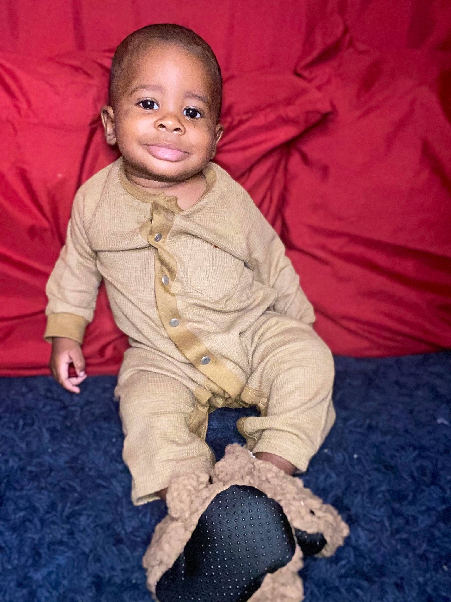 Lawrence is registered to the contest to win money with this photo: baby, baby_toddler_clothing, cheek, child, comfort, flash_photography, flooring, foot, fun, grass, happy, joy, person, portrait_photography, sitting, skin, sleeve, smile, soil, textile