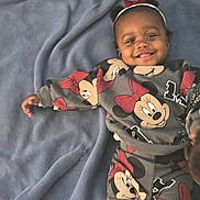 Skyla is registered to the contest to win money with this photo: baby, blanket, blue_blanket, child, clothing, cute, fabric, happy, headband, indoor, infant, lying_down, minnie_mouse, patterned_clothes, person, playful, portrait, red_bow, smiling, toddler