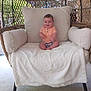 Maverick is registered to the contest to win money with this photo: architecture, armchair, baby, building, chair, clothing, couch, cushion, face, furniture, head, homedecor, newborn, outdoors, person, photography, portrait, shelter, shorts, sitting
