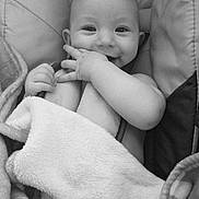 Emmett joined the competition — help win amazing prizes! baby, infant, smiling, blanket, cushion, seat, hand, face, cute, child, black_and_white, portrait, cozy, comfort, happy, indoors, person, young, expression, resting