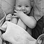 baby, infant, smiling, blanket, cushion, seat, hand, face, cute, child, black_and_white, portrait, cozy, comfort, happy, indoors, person, young, expression, resting