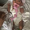Jha Lani joined the competition — help win amazing prizes! newborn, baby, infant, hospital, hospital_bed, lying_down, portrait, face, pacifier, pacifier_chain, pink_bow, headband, onesie, blanket, bedsheets, medical_bracelet, green_sock, sleeping_area, indoors, cute