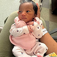Jha Lani is registered to the contest to win money with this photo: newborn, baby, infant, child, portrait, indoors, hospital, pink_outfit, onesie, dark_hair, awake, face, eyes, hands, feet, adult_arm, holding, blanket, seated, close_up