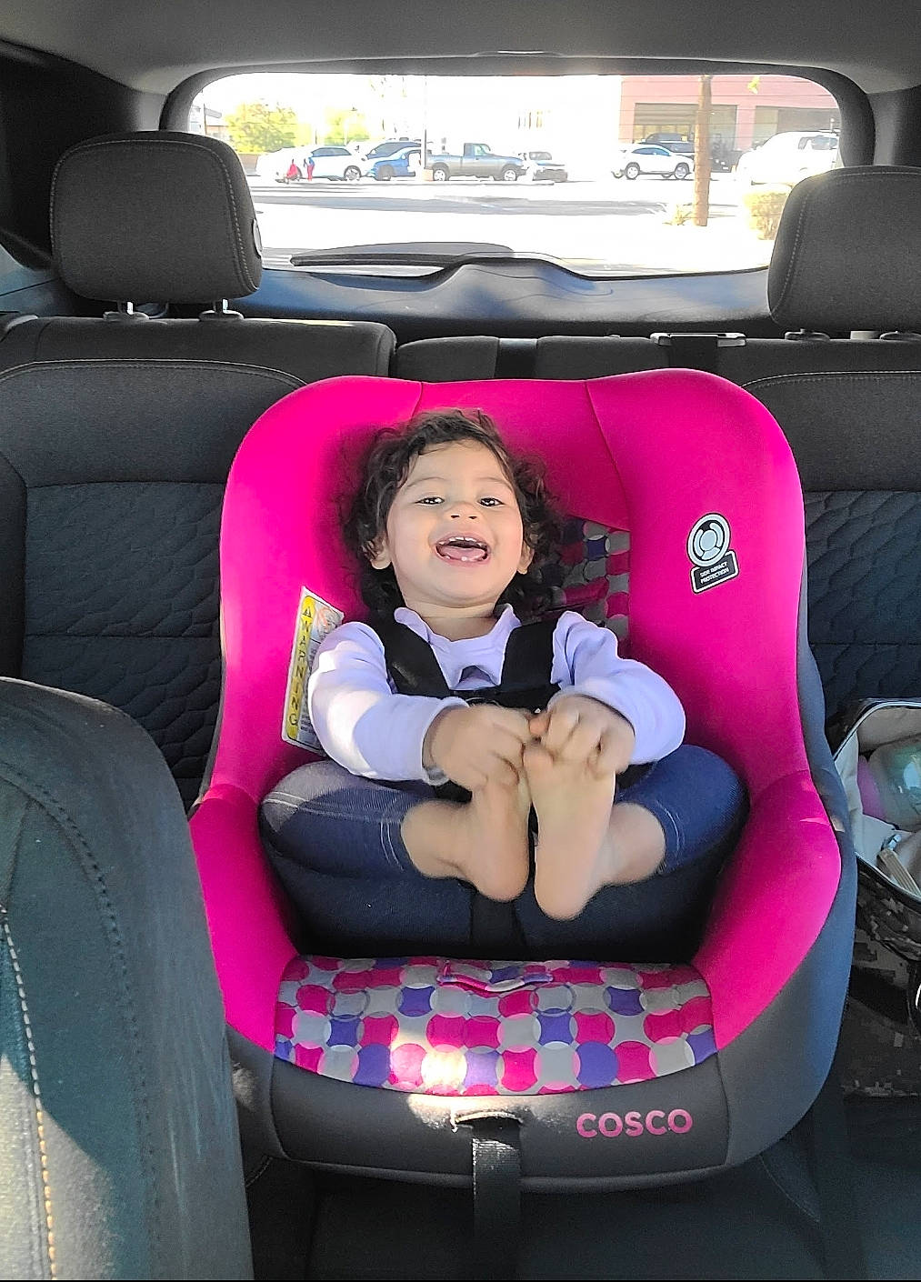 Adelynn is registered to the contest to win money with this photo: auto_part, automotive_design, automotive_exterior, car, car_seat, car_seat_cover, comfort, family_car, head_restraint, joy, luxury_vehicle, mode_of_transport, motor_vehicle, person, personal_luxury_car, plant, smile, tints_and_shades, toddler, vehicle