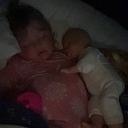 Kimber is registered to the contest to win money with this photo: bed, blanket, child, comfort, cozy, cuddle, dark, doll, face, indoor, infant, nighttime, pajamas, peaceful, person, portrait, quiet, rest, sleeping, soft_light