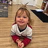 Kimber is registered to the contest to win money with this photo: toddler, child, smiling, indoor, wooden_floor, sweater, long_sleeves, hair_tuft, happy, playful, person, floor, room, door, shelves, clothing, candid, young_child, cute, casual